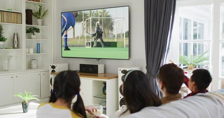 Canvas Print - Composite of happy family sitting at home together watching hockey match on tv