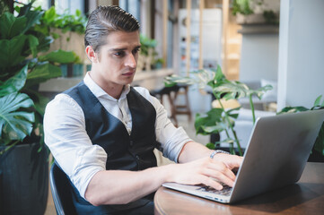 Wall Mural - confident professional businessman working with laptop in modern business office workplace, executive manager man with computer technology, male businessman entrepreneur startup