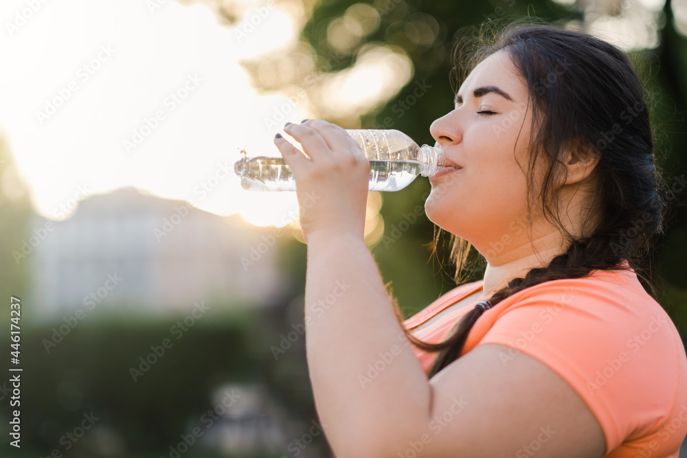 Dehydrated woman. Water thirst. Nutrition wellness. Body healthcare. Side view portrait of obese overweight drinking lady in defocused copy space sunset background. - obrazy, fototapety, plakaty 