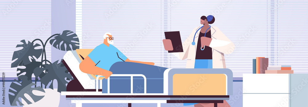 nurse taking care of sick senior man patient lying in hospital bed care service concept horizontal - obrazy, fototapety, plakaty 