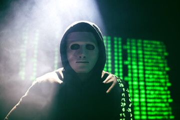 Wall Mural - Hacker in mask on dark background