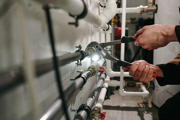 Wall Mural - Hands of technician or plumber repairing broken pipes in toilet