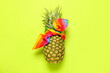 Fresh pineapple in kerchief on color background