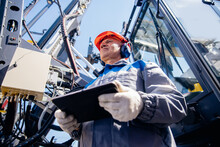 Industry Operator Use Mobile Tablet For Control Drilling Rig For Exploration Of Minerals For Oil, Gas And Artisan Water