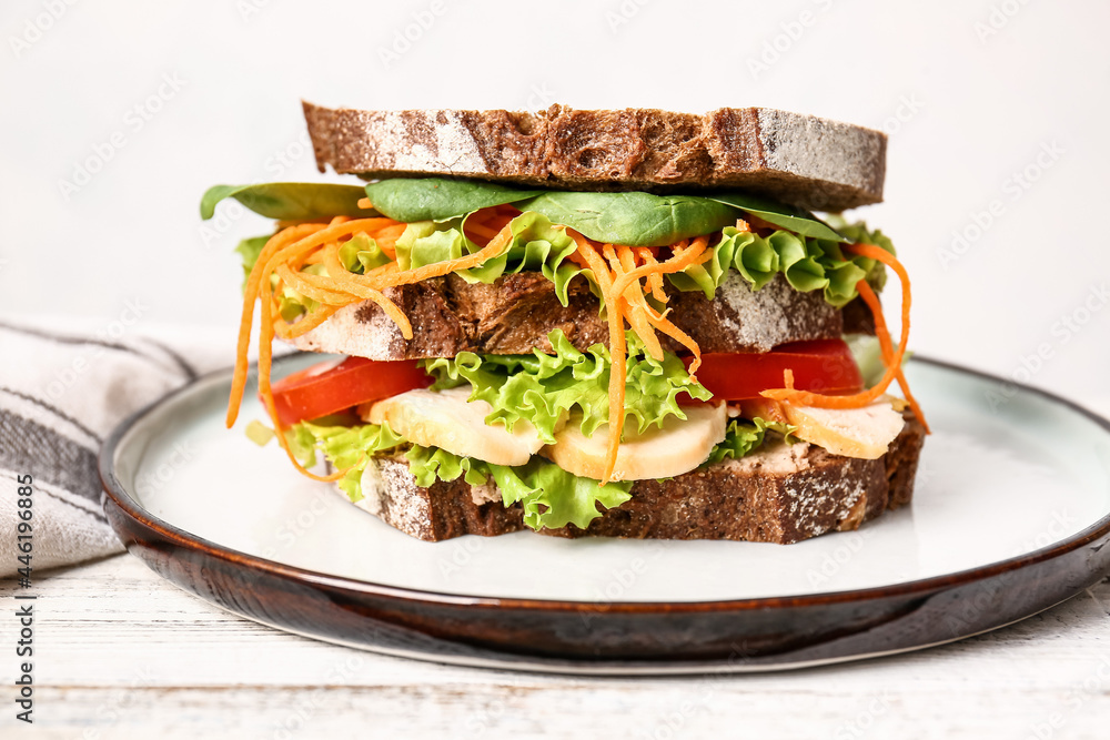 Plate with tasty sandwich on light wooden table, closeup
