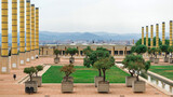 Fototapeta Paryż - Square with greenery and columns, view of Barcelona