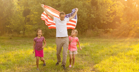 Wall Mural - Happy family in field with USA, american flag on back.