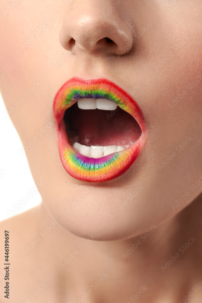 Beautiful young woman with rainbow lips, closeup