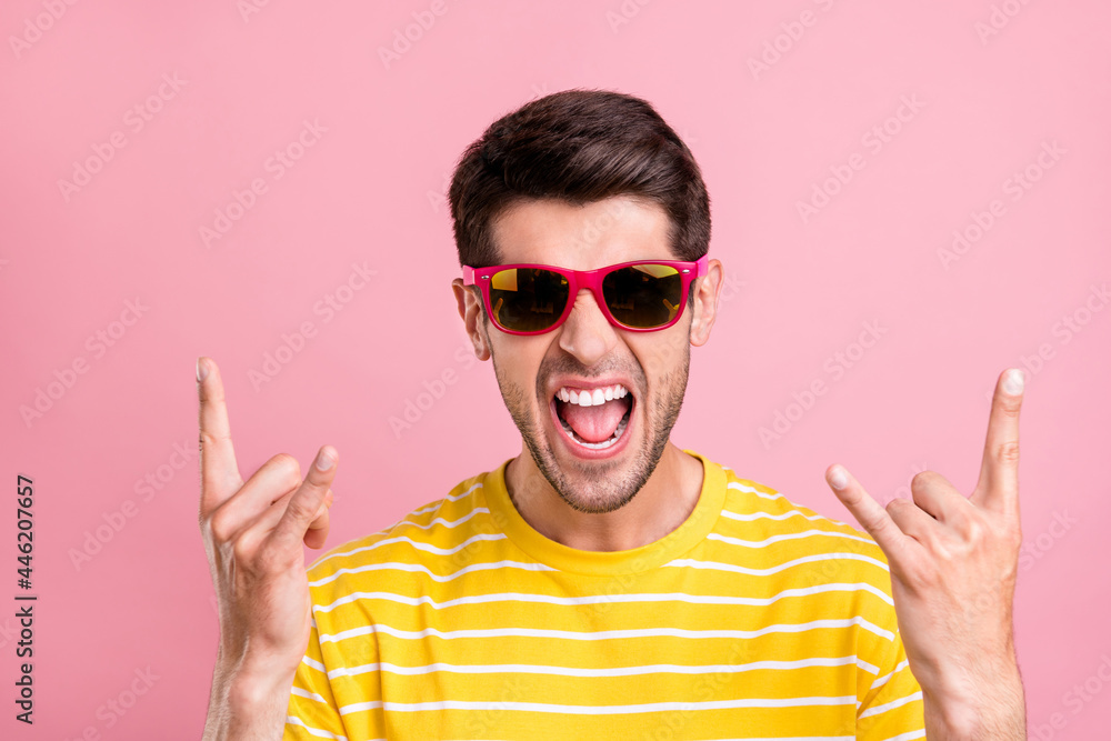 Portrait of attractive naughty crazy cheerful guy showing horn sign having fun isolated over pink pastel color background - obrazy, fototapety, plakaty 