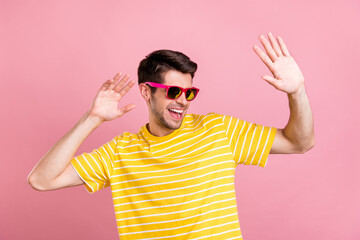 Poster - Portrait of attractive fashionable cheerful guy dancing having fun isolated over pink pastel color background