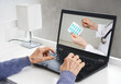 © Dmytro - Online doctor for the elderly concept. An old woman is watching a stream on a laptop about medications.