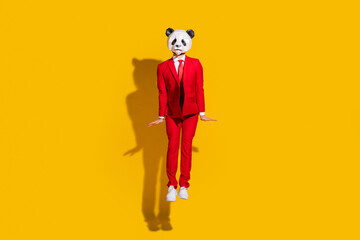 Sticker - Photo of shy boyfriend panda guy jump posing wear mask red suit footwear isolated on yellow color background