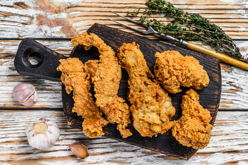 Wall Mural - Crispy chicken drumstick, leg, wing and breast strips. White Wooden background. Top view