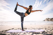 © Jacob Lund - Woman doing Natarajasana yoga pose on beach