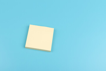 Wall Mural - yellow sticky notes on blue background. Square sticky paper reminders with shadows