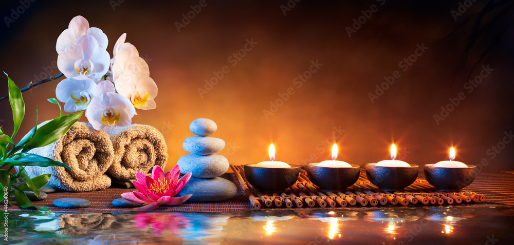 Spa Massage Stones With Candles And Towels On Bamboo Mat - Meditation Concept - obrazy, fototapety, plakaty 