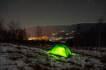 Wall Mural - tent in the winter in the mountains with a view of the night city