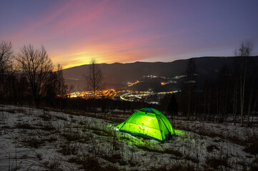 Wall Mural - tent in the winter in the mountains with a view of the night city