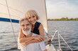 © luengo_ua - Romantic vacation and luxury travel. Senior loving couple sitting on the yacht deck. Sailing the sea.