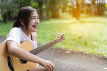 Beautiful Girl Playing Guitar At The Garden
