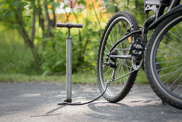 A pump and a bicycle. Bicycle repair in the forest. Close up