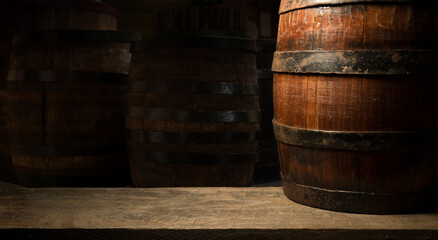 Wall Mural - Pouring red wine into the glass against wooden background