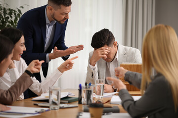 Wall Mural - Boss scolding employee at workplace in office