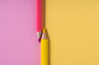 Pink and yellow pencils on pastel pink and yellow contrast background. education concept.top view.place for text