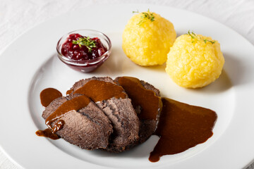 closeup of a german sauerbraten with dumplings