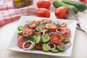 Wall Mural - Fresh vegetable salad with cucumber, tomato and red onion