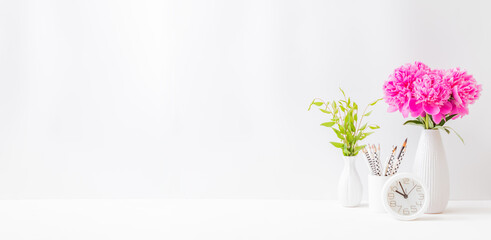 Wall Mural - Home office desktop with pink peonies in a vase on a light background