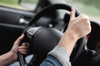 © Natali - Female hands on the car steering wheel close up. Woman is driving a car.