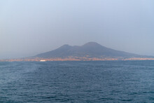 Defocused Background Of Vesuvius And The City Of Naples Seen From The Sea.