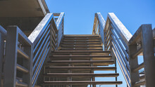 Closeup Of A Metal Staircase Of A Building Under The Sunlight And A Blue Sky