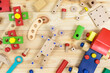 © Natali - A colorful wooden building kit, wooden robot for children on wood. Set of tools on wooden table. Games and tools for kids in preschool or daycare. Natural, eco-friendly toys.