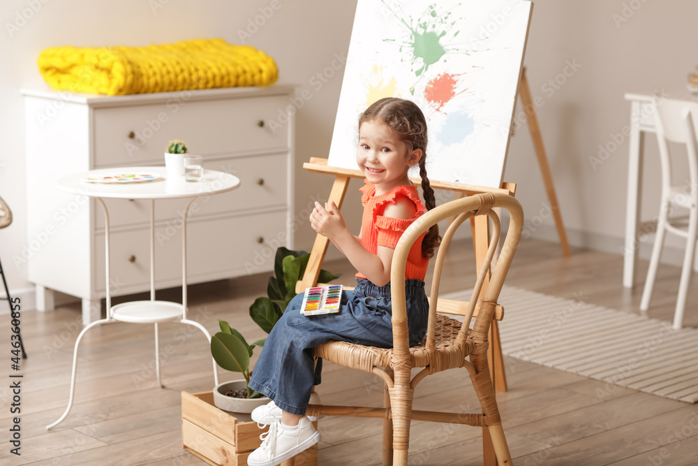 Cute little artist painting at home