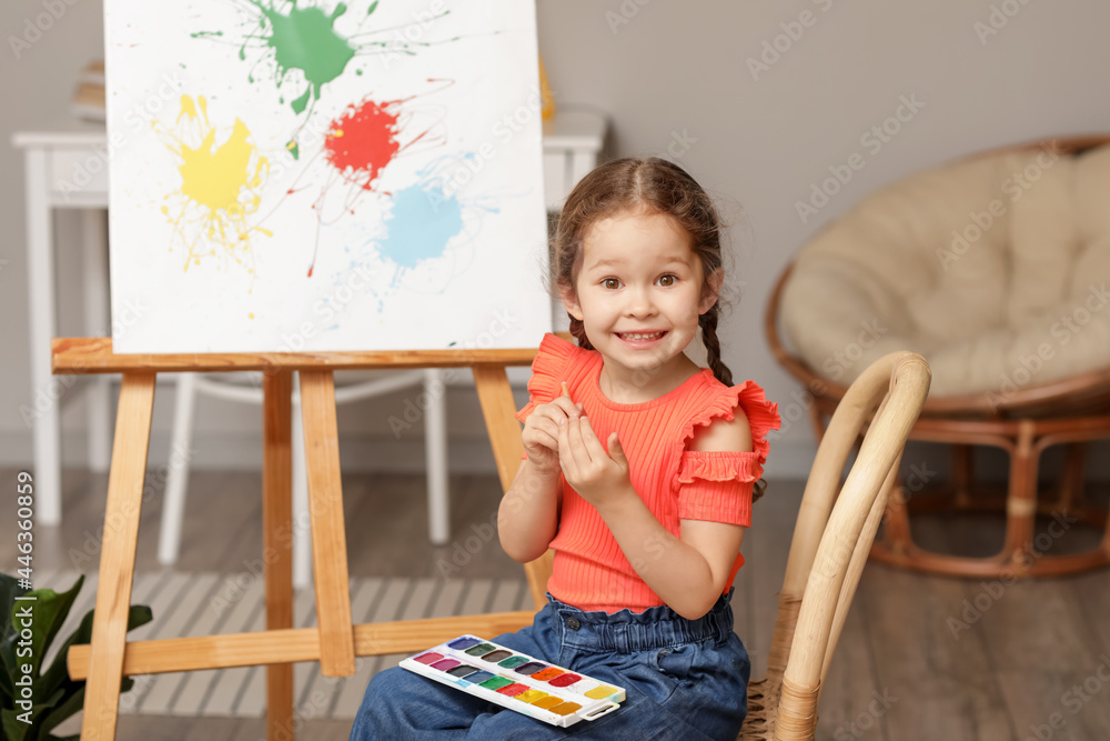 Cute little artist painting at home