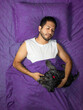 © Narayan - latin man sleeping in bed with his friend dog, sleep concept
