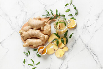 Composition with fresh ginger and honey on light background