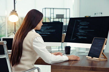 Programmer working at desk in modern office