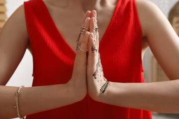 Wall Mural - Woman with henna tattoo on hand, closeup. Traditional mehndi ornament