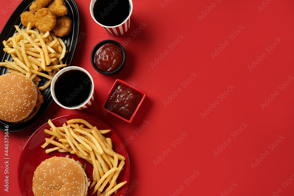 Different fast food on red background, flat lay. Space for text - obrazy, fototapety, plakaty 