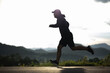 © Chanakon - Silhouette Young man wearing sportswear running outdoor nature mountain background. Man jogging on the country side road. Training athlete outdoor concept.