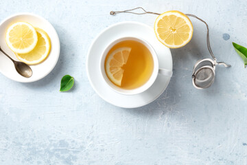 Poster - Lemon tea in a cup, shot from above with a place for text. Healthy organic detox citrus drink. Vegan morning beverage