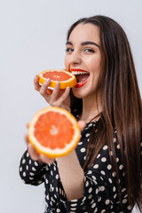 Wall Mural - Pretty young woman with citrus. Beautiful female posing for camera with orange.