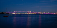 Auckland Sky Tower Illuminated In Pink And Harbour Bridge In Purple