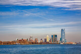 Fototapeta Nowy Jork - Ellis Island in front of Jersey City, New York and Jersey City