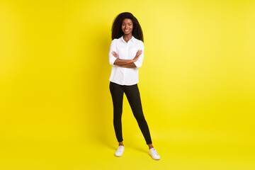 Sticker - Full length body size photo of smiling girl with crossed hands confident wearing white shirt isolated on bright yellow color background