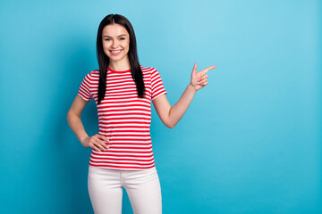 Wall Mural - Photo of happy good mood beautiful sweet girl advertising product point finger copyspace isolated on blue color background