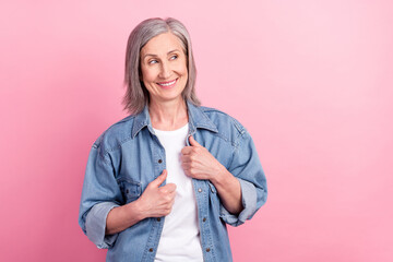 Poster - Photo of cute shiny age woman dressed jeans outfit smiling arms shirt looking empty space isolated pink color background